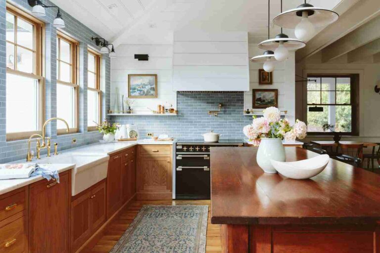7 Ways to Modernize an Old Kitchen without a Full Remodel kitchen-with-brown-cabinets-and-large-island-in-the-center-on-it-there-is-a-white-bowl-and-vase-with-flowers