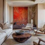 a-light-colored-L-shaped-sofa-with-patterned-pillows-site-on-large-area-rug