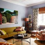 cozy-living-room-with-mix-of-colors-and-textures-and-a-wall-have-a-light-blue-textured-wallpaper-with-painting-on-a-wall