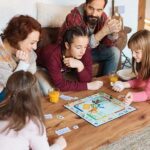 family-of-five-gathered-around-a-wooden-coffee-table-in-a-cozy-living-room-engaged-in-a-board-game