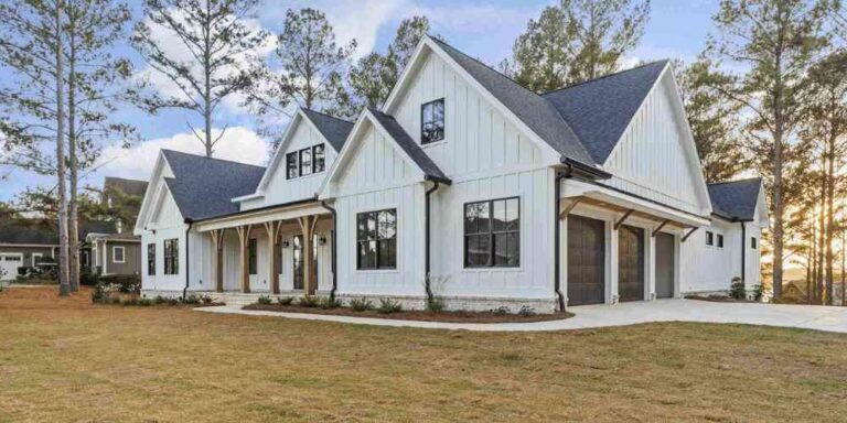 large-two-story-single-family-residence-with-white-siding-with-dark-trimmed-window-and-dark-roof