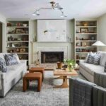 living-room-that-emphasizes-symmetry-and-a-neutral-color-palette-with-blue-accents-the-design-features-two-white-sofas