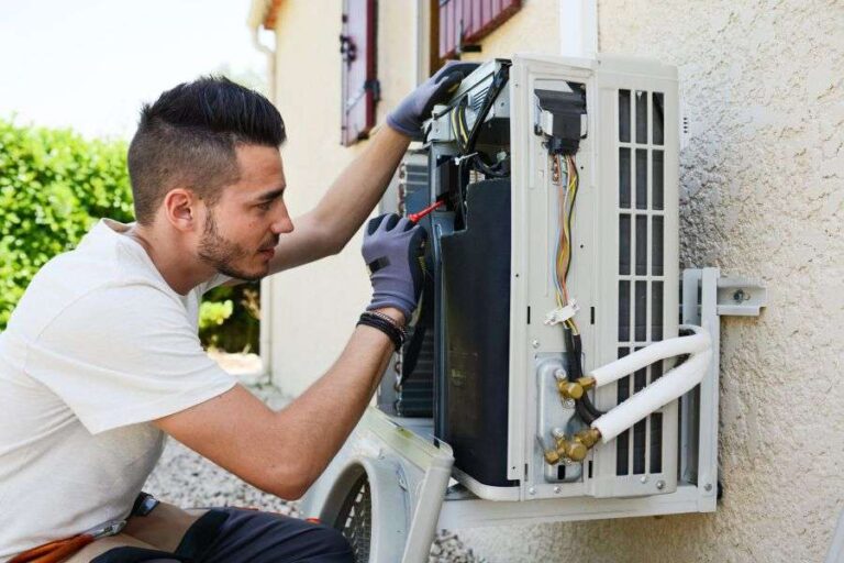 technician-installing-an-outdoor-air-conditioning-compressor-unit-and-it-is-mounted-on-a-wall-bracket