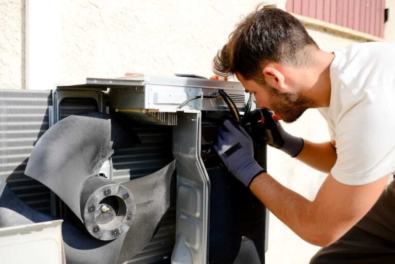 technician-performing-a-tune-up-on-an-air-conditioning-unit-he-is-replacing-or-cleaning-the-filter-to-ensure-proper-airflow
