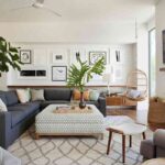 the-room-features-a-large-area-rug-with-a-geometric-pattern-a-large-blue-sectional-sofa