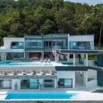 the-villa-is-a-multi-level-modern-architecture-charaterized-by-its-sleek-white-surface-and-use-of-floor-to-ceiling-glass