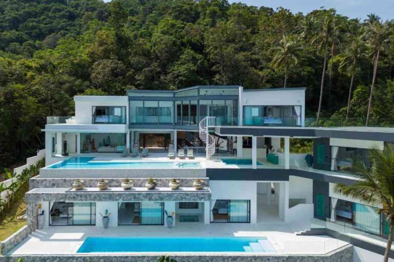 the-villa-is-a-multi-level-modern-architecture-charaterized-by-its-sleek-white-surface-and-use-of-floor-to-ceiling-glass