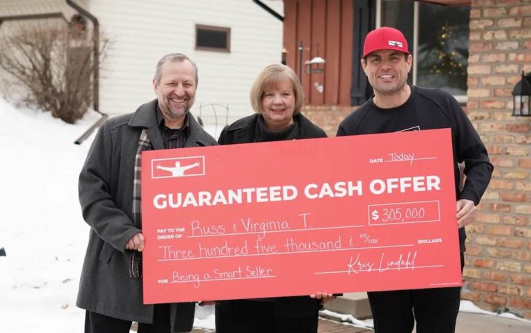 three-people-standing-outdoor-in-a-snowy-environment-holding-a-large-promotional-check