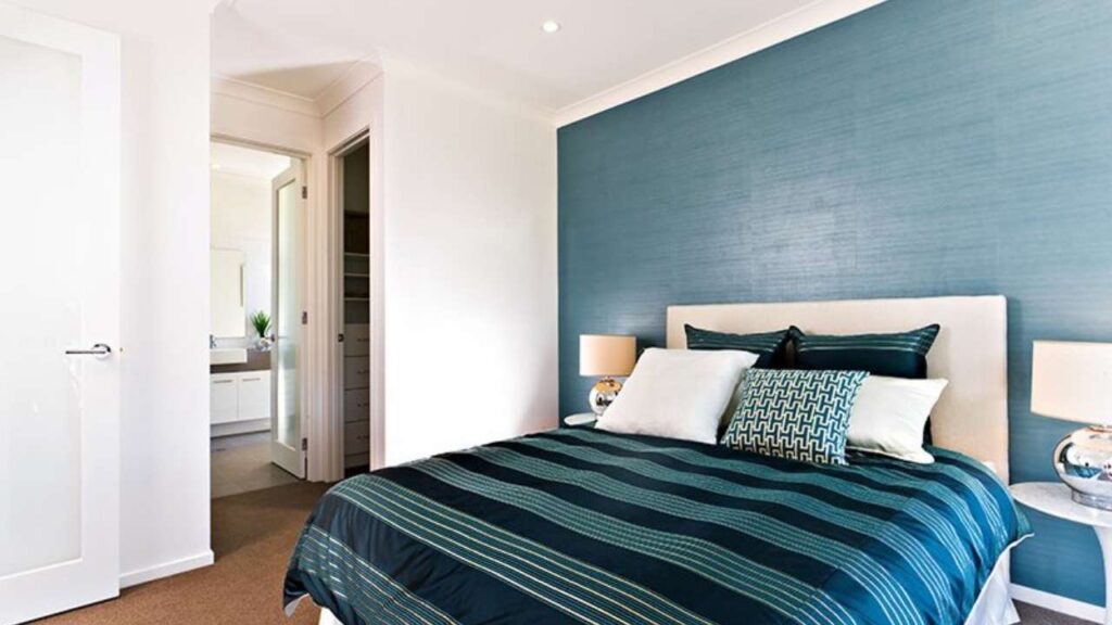 An Image of Bedroom Painted with off White and Blue on Accent Wall