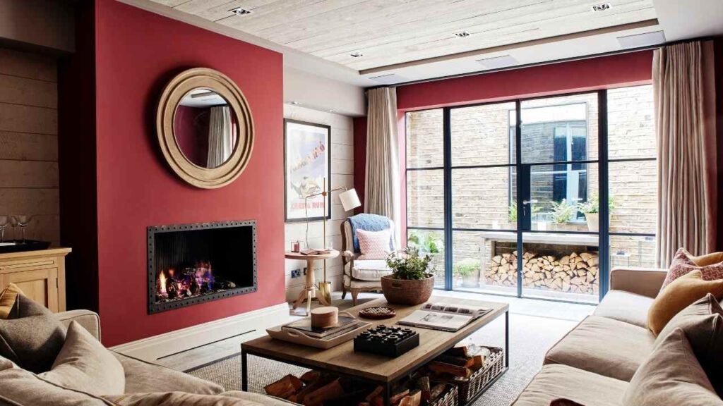 An Image of Living Room painted with off White And Red Accent wall