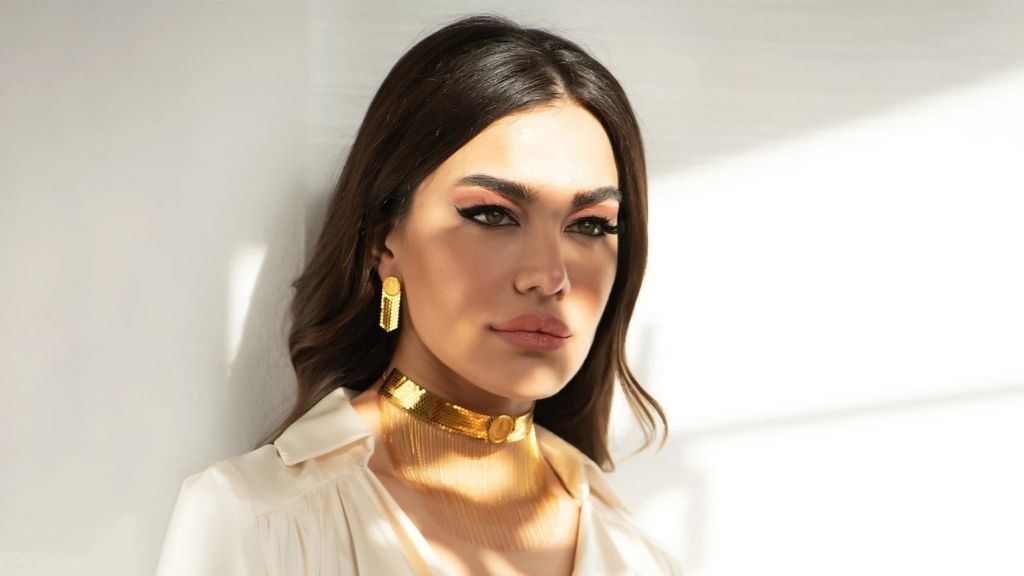 An Image of White Top With Gold Jewelry