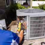 HVAC-technician-performing-a-maintenance-or-repairs-on-an-outdoor-central-air-conditioning-unit