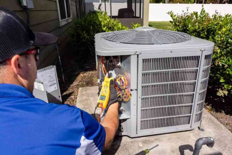 HVAC-technician-performing-a-maintenance-or-repairs-on-an-outdoor-central-air-conditioning-unit