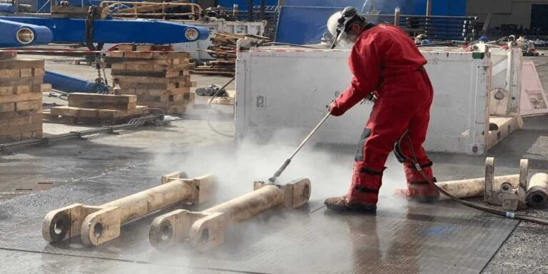 a-man-performing-high-pressure-water-jetting-this-cleaning-process-uses-powerful-water-streams-to-remove-paint-etc