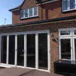 a-set-of-four-panel-bifolding-doors-which-fold-back-to-create-a-wide-open-transition-between-indoor-and-outdoor-space