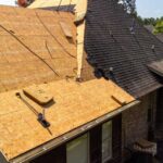 house-roof-replacement-a-large-portion-of-the-roof-has-had-its-old-shingles-removed-revealing-the-underlying-wooden-roof-decking