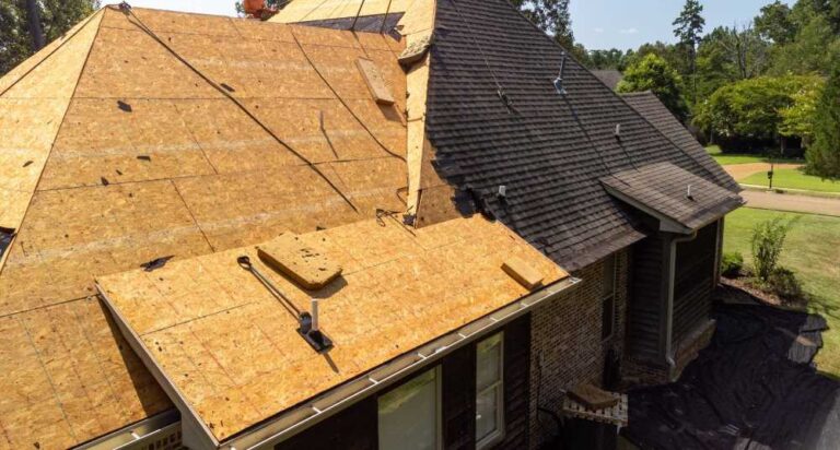 house-roof-replacement-a-large-portion-of-the-roof-has-had-its-old-shingles-removed-revealing-the-underlying-wooden-roof-decking