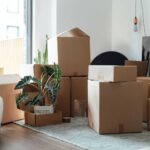 modern-living-room-filled-with-various-sized-cardboard-moving-boxes-indicating-a-household-relocation