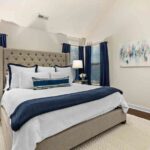 small-bedroom-design-centered-around-a-queen-size-bed-the-room-features-neutral-color-palette-with-bold-navy-blue-accents-seen-in-the-floor