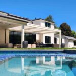 the-outdoor-of-a-modern-home-features-a-geometric-heated-pool-and-a-private-patio