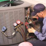 HVAC-technician-performing-maintenance-or-repair-on-an-outdoor-central-air-conditioning-unit