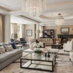a-bright-spacious-and-living-room-interior-features-a-large-light-colored-L-shaped-sectional-sofa-is-positioned