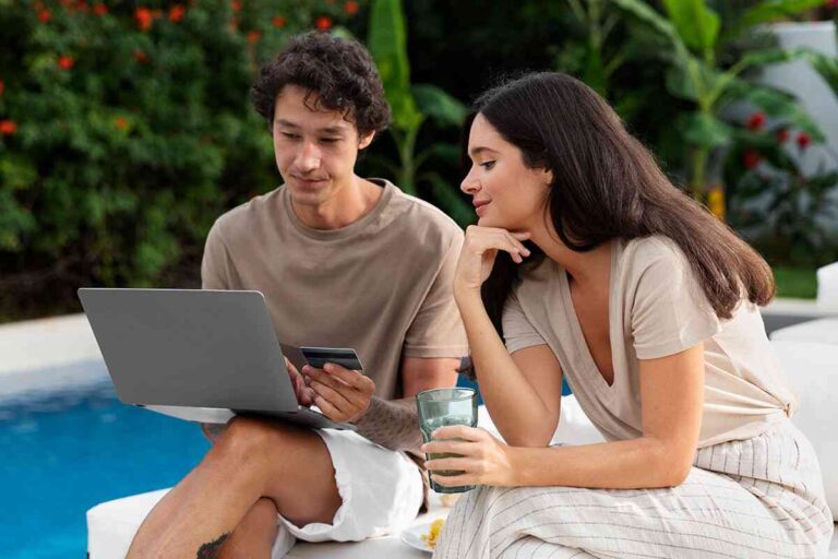 5 Outdoor Technology Trends Homeowners Are Actually Using a-girl-and-boy-sitting-near-a-pool-boy-is-using-laptop-and-girl-watching-the-screen