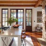 a-modern-kitchen-sitting-space-the-space-is-defined-by-exposed-wood-ceiling-beams-and-large-glass-paned-doors