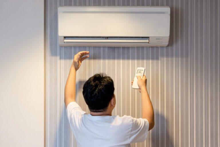 Simple HVAC Maintenance Tips Every Homeowner Should Know a-person-performing-DIY-maintenance-on-a-wall-mounted-mini-split-air-conditioning-unit