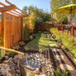 a-prominent-cedar-colored-pergola-with-a-trellised-privacy-screen-serves-as-a-focal-pint-and-provides-a-sense-of-enclosure