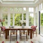 bright-dining-room-inside-a-glass-garden-room-extension-filled-with-abundant-natural-light