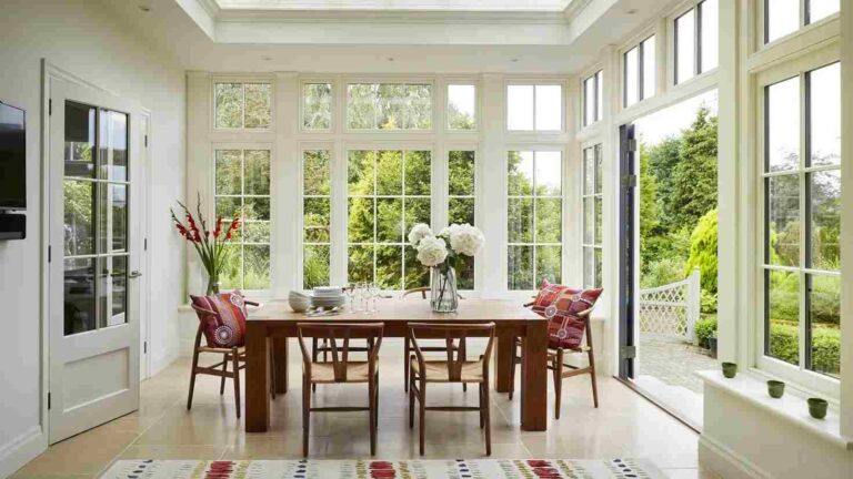 How Natural Light Can Completely Change Your Living Space bright-dining-room-inside-a-glass-garden-room-extension-filled-with-abundant-natural-light