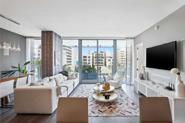 bright-modern-luxury-living-room-the-room-has-a-clean-minimalist-design-with-white-furniture-including-sofas-and-chairs-a-small-round-coffee-table-in-the-center