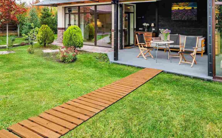 Smart Ways to Protect Your Property and Landscaping on Moving Day contemporary-backyard-design-featuring-a-long-straight-wooden-garden-pathway-extending-across-the-lawn