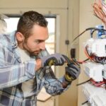 male-electrician-working-on-complex-electrical-panel-or-wiring-system