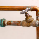 old-plumbing-pipes-it-is-rusty-and-corroded-with-a-small-metal-valve-attached-in-the-center-copper-pipes-are-also-available