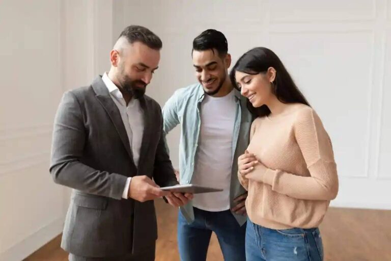 real-estate-agent-showing-an-apartment-listing-on-a-tablet-to-a-young-couple