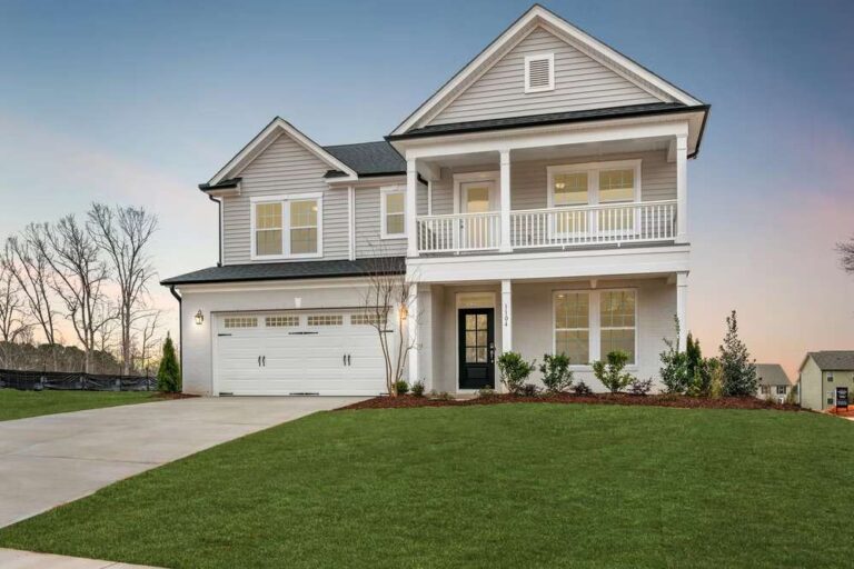 The Growing Interest in Homes That Feel Private and Peaceful traditional-american-suburban-home-design-white-horizontal-siding-covers-most-of-the-exterior-paired-with-vertical-board-and-batten-siding-on-the-gables
