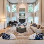 a-brightly-luxury-living-room-with-large-modular-sectional-sofa-frames-the-foreground-decorated-with-distinct-dark-blue-and-white-geometric-patterned-throw-pillows
