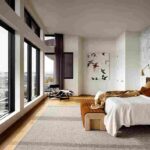 a-high-ceilinged-penthouse-main-bedroom-with-an-etire-wall-made-of-floor-to-ceiling-window-offering-panoramic-outdoor-view