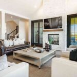 a-large-modern-open-concept-living-area-with-a-clean-and-airy-design-the-space-is-anchored-by-a-large-crisp-white-L-shaped-sectional-sofa