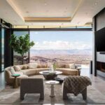 a-luxury-modern-residence-characterized-by-an-open-floor-plan-and-expansive-floor-to-ceiling-glass-walls-a-sectional-sofa-centers-the-room