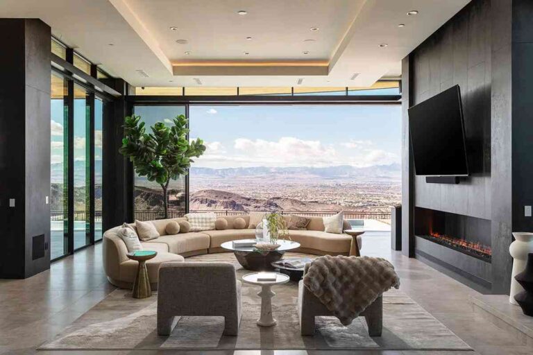 a-luxury-modern-residence-characterized-by-an-open-floor-plan-and-expansive-floor-to-ceiling-glass-walls-a-sectional-sofa-centers-the-room