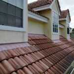 a-residential-home-featuring-a-roof-that-is-covered-in-reddish-brown-s-shaped-interlocking-barrel-tiles