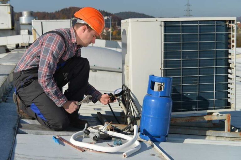 Avoid Costly Damage With Immediate HVAC Emergency Service a-technician-is-wearing-a-safety-helmet-and-inspecting-or-connecting-components