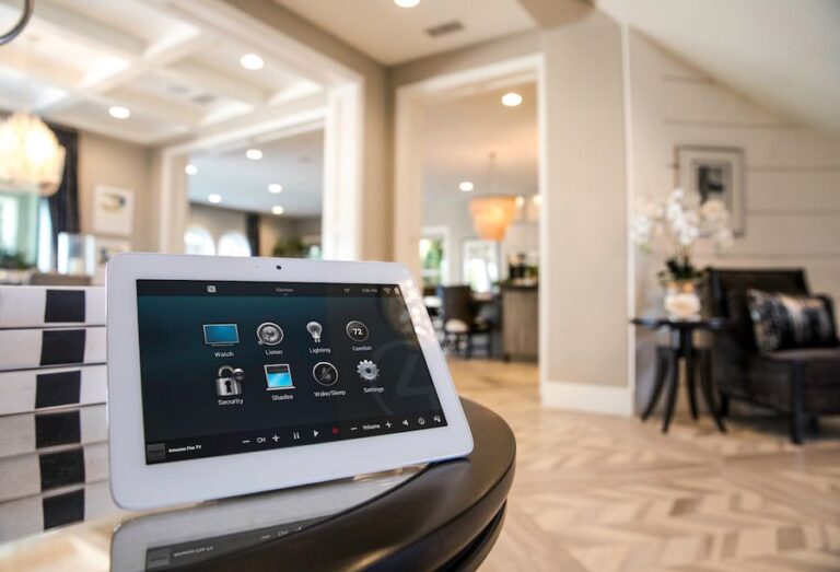 a-white-bezel-tablet-interface-sits-angled-on-a-curved-dark-countertop-its-display-features-a-grid-of-colorful-menu-icons-for-managing-integrated-home