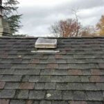 an-aging-residential-roof-covered-in-weathered-gray-and-dark-brown-asphalt-shingles