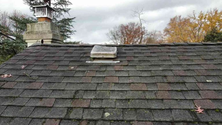 How to Spot Roof Trouble Before It Gets Expensive an-aging-residential-roof-covered-in-weathered-gray-and-dark-brown-asphalt-shingles
