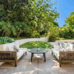 outdoor-patio-living-space-designed-for-relaxation-it-features-a-modern-seating-arrangement-with-two-woven-textured-sofas