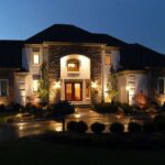 the-home-is-a-multi-story-symmetrical-estate-with-stone-accents-and-a-grand-central-entryway